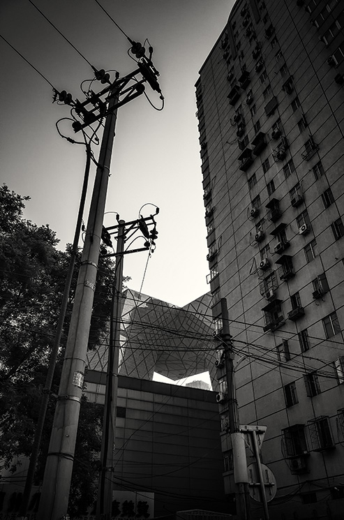 Utility poles, apartment block and CCTV building at Chaoyang Raod, Chaoyang, Beijing, China.