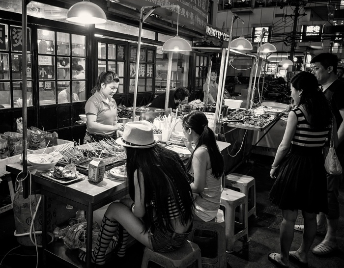 Girls dine out at a street cafe at Sanlitun Village, Sanlitun, Beijing, China.