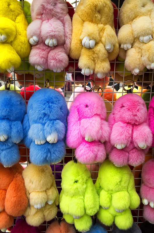 Cuddly toys in the shape of rabbits hang from a rack outside a store on Yabao Road, Russia Town, Beijing, China.