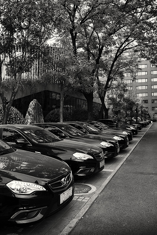 Fleet of cars parked outside business premises at Beijing Xiyu Unit Culture Creativity Centralization Area, Chegongzhuang S Street, Xicheng, Beijing, China.